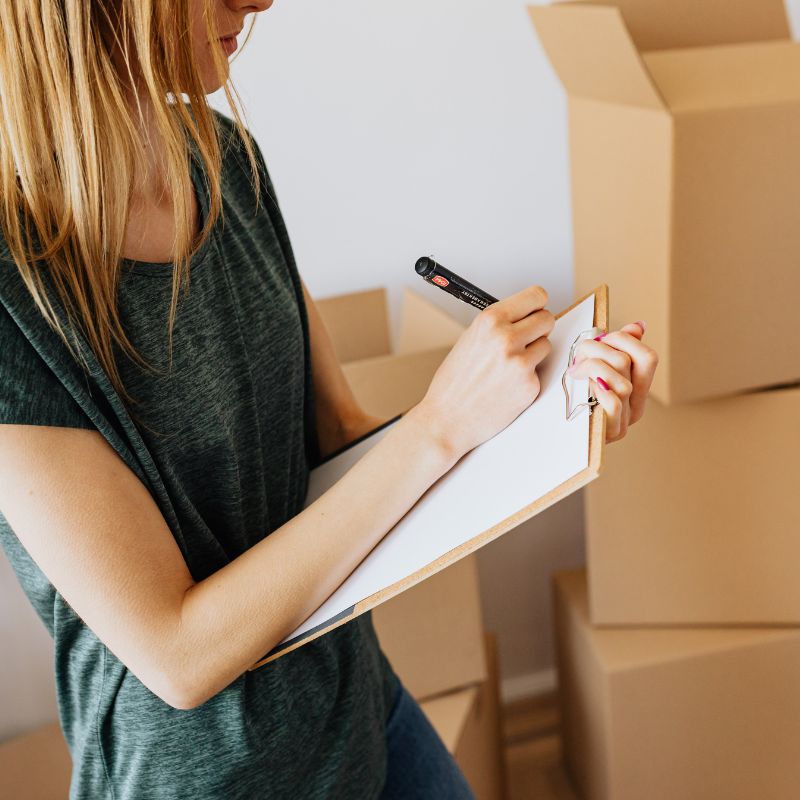 Person holding a clipboard representing checks for renting a property in Bournemouth